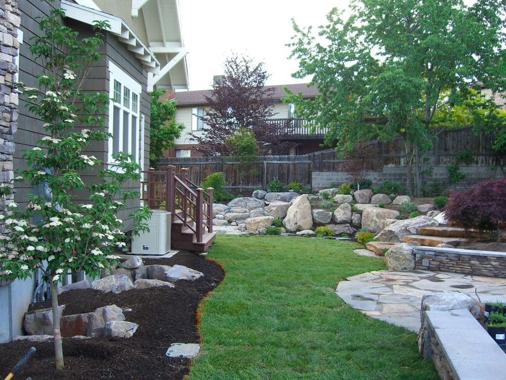 Lush backyard with stone pathways, water features, and landscaped greenery. Perfect for outdoor living.